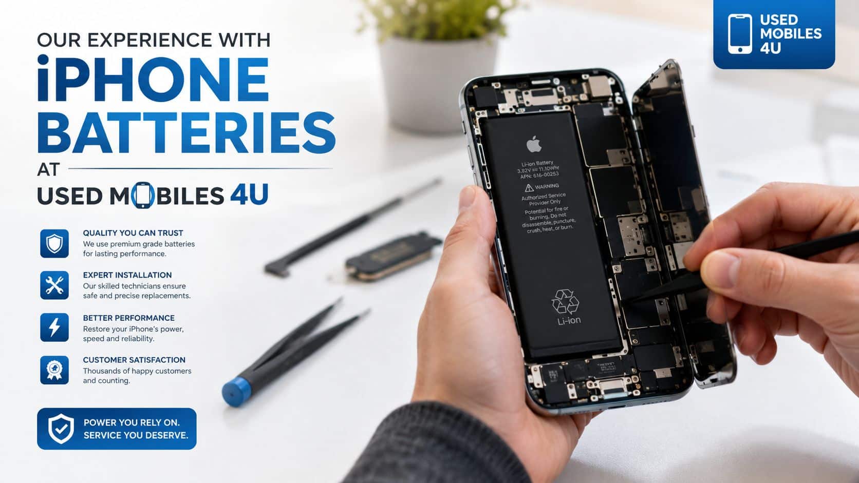 A technician carefully repairs an open iPhone, highlighting professional battery replacement services at Used Mobiles 4 U.